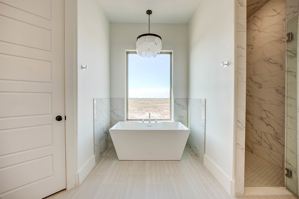 View of isolated ceramic bath tub in amazing master bath of beautiful new home for sale in Lubbock.