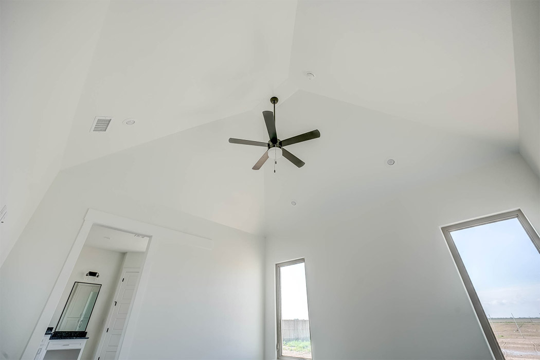 Spacious master bedroom with vaulted ceiling in beautiful new Lubbock home for sale.