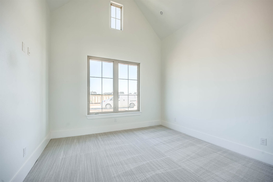 Spacious bedroom or home office with vaulted ceiling, in new home for sale in Lubbock, Texas.
