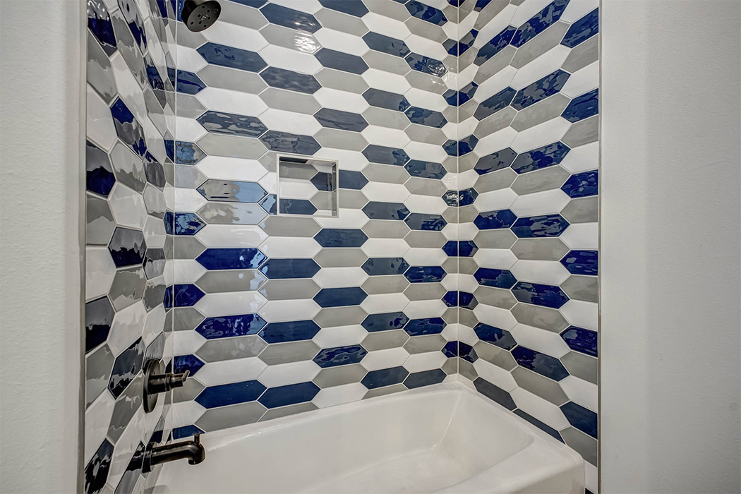Detail of beautiful shower tile work in jack-and-jill or secondary bath in new Lubbock home.