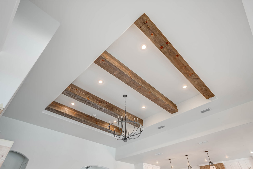 Alternate view of beautiful wood beam ceiling in living area of new Lubbock home.