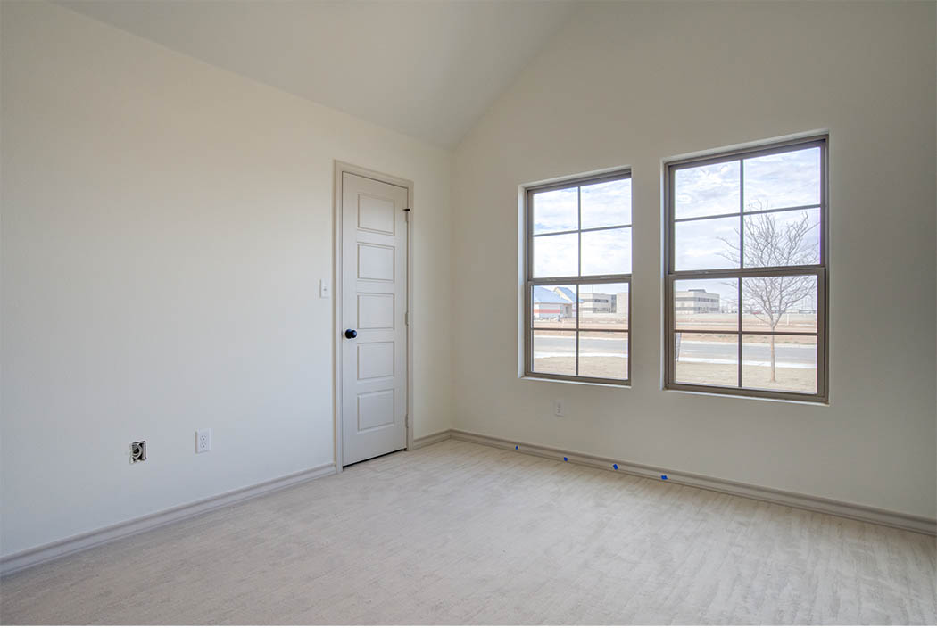 View of bedroom windows and closet door in new home for sale in Lubbock.
