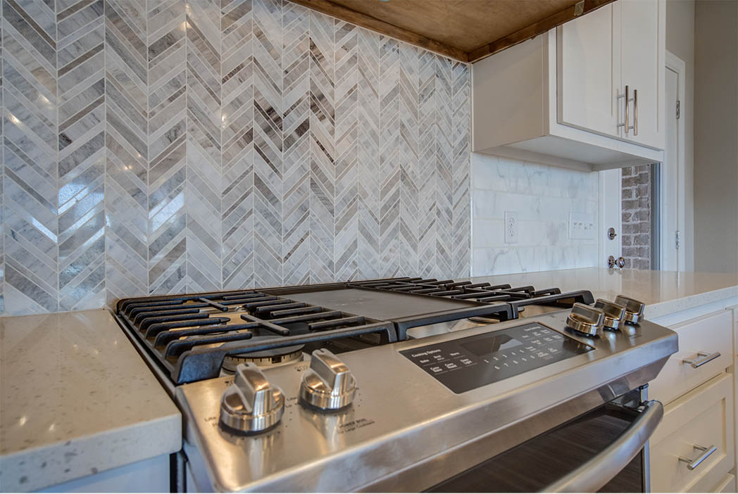 Detail of stove and backsplash in kitchen of new home for sale in West Texas.