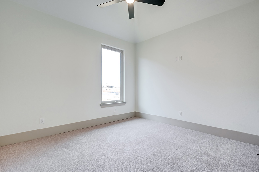 Spacious bedroom with vaulted ceiling in a beautiful new Lubbock home for sale.