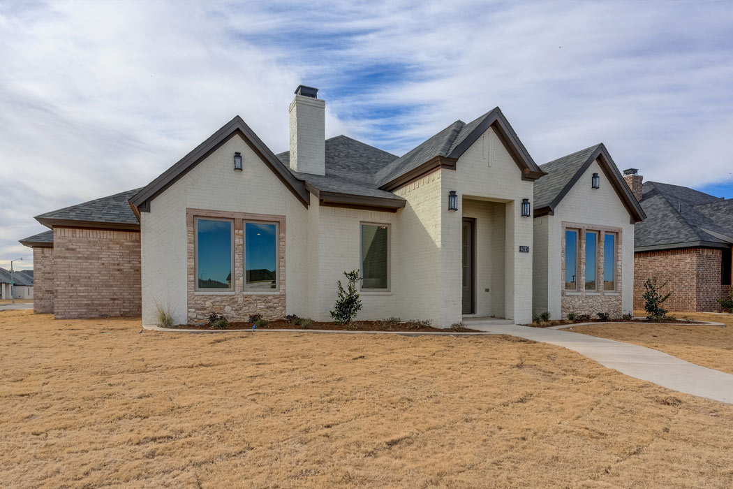 Alternate exterior view of gorgeous home for sale in Lubbock, Texas, featuring an Austin stone exterior.