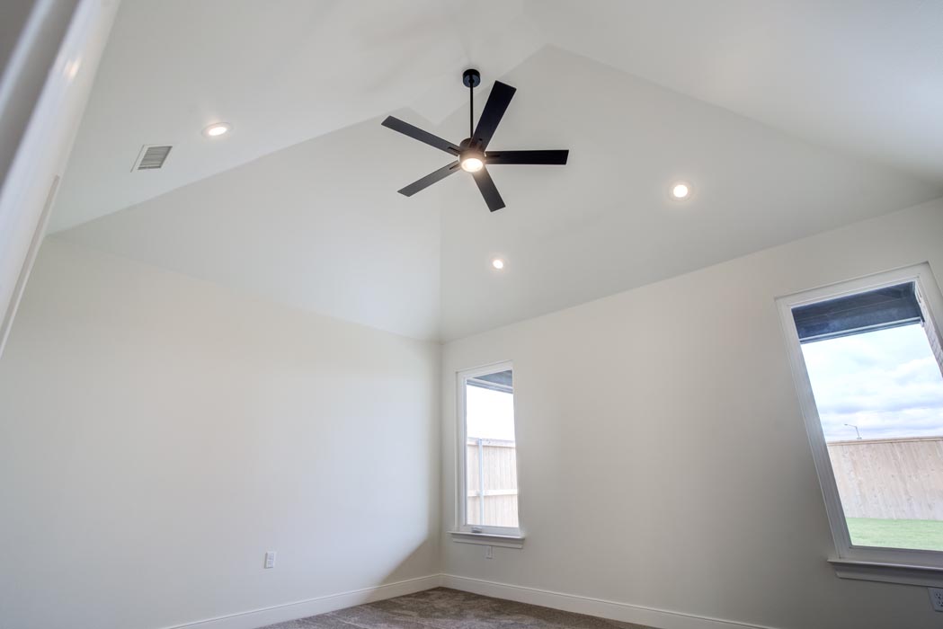 Spacious bedroom in new home for sale in Lubbock, Texas with vaulted ceiling.