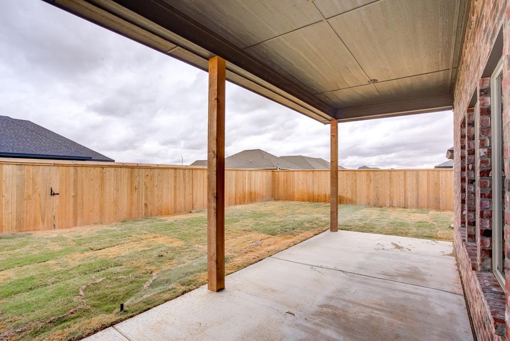 Covered patio and backyard of new home for sale in Lubbock.