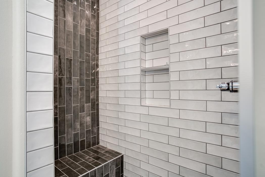 Detail of shower tile work in master bath in new Lubbock home.