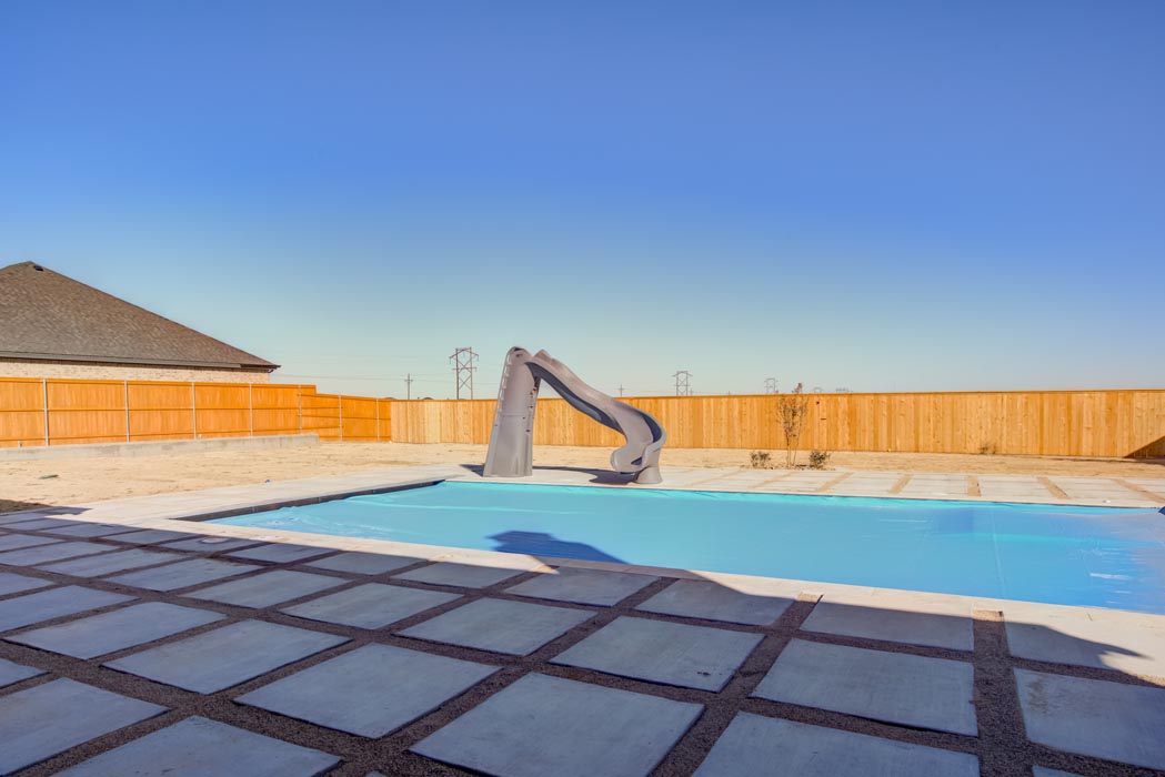 Beautiful outdoor backyard with pool in home built by Sharkey Custom Homes in Lubbock.