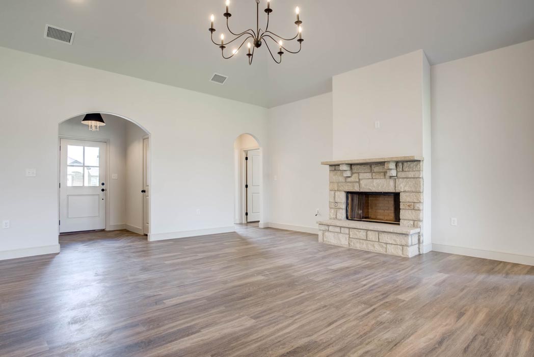 Spacious living area and great room in new home for sale in Lubbock, Texas with vaulted ceiling.