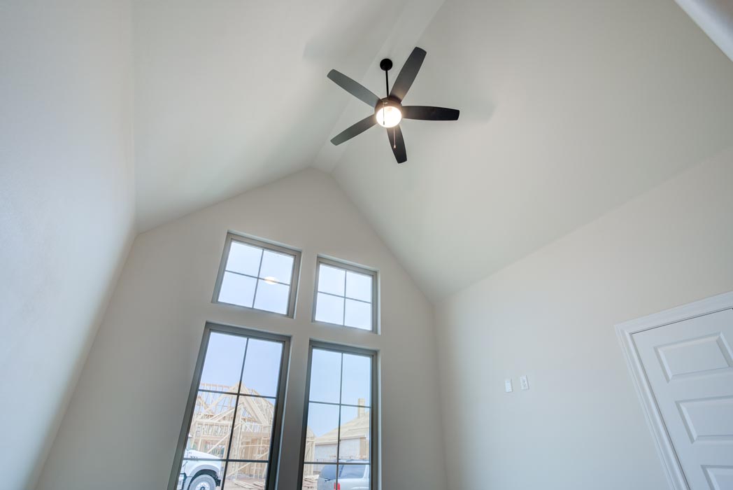 Vaulted ceiling with ceiling fan in guest bedroom of home for sale in Lubbock.