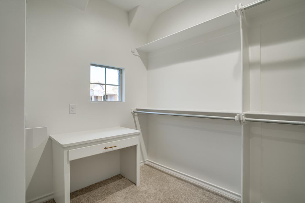 Spacious master closet with built-in dressing vanity in new home in Lubbock, Texas.