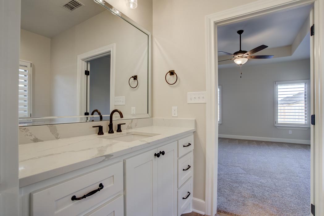 Vanity and mirror in master bath in new Lubbock home for sale.
