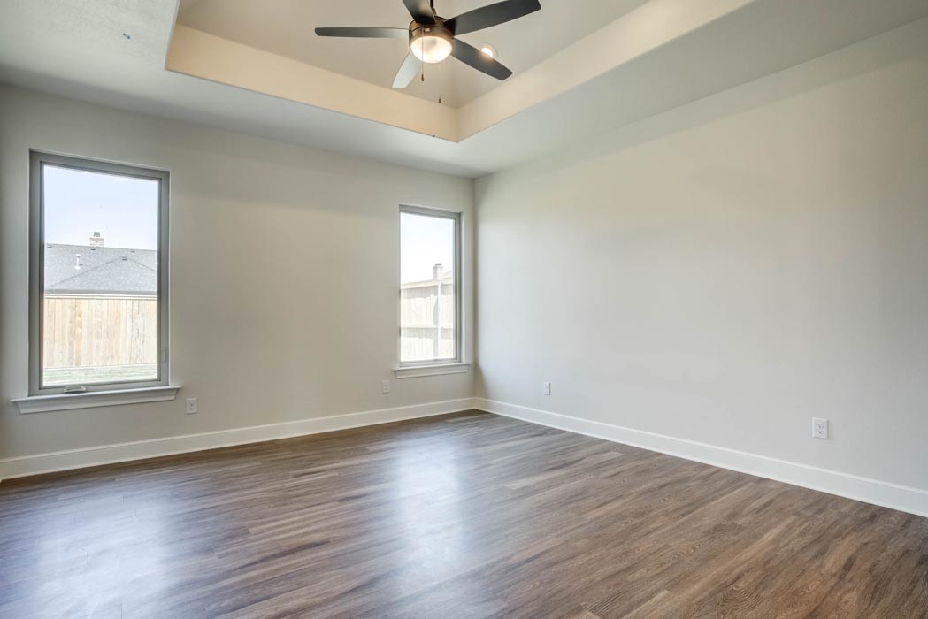 Spacious bedroom with special ceiling treatment in new Lubbock home for sale.