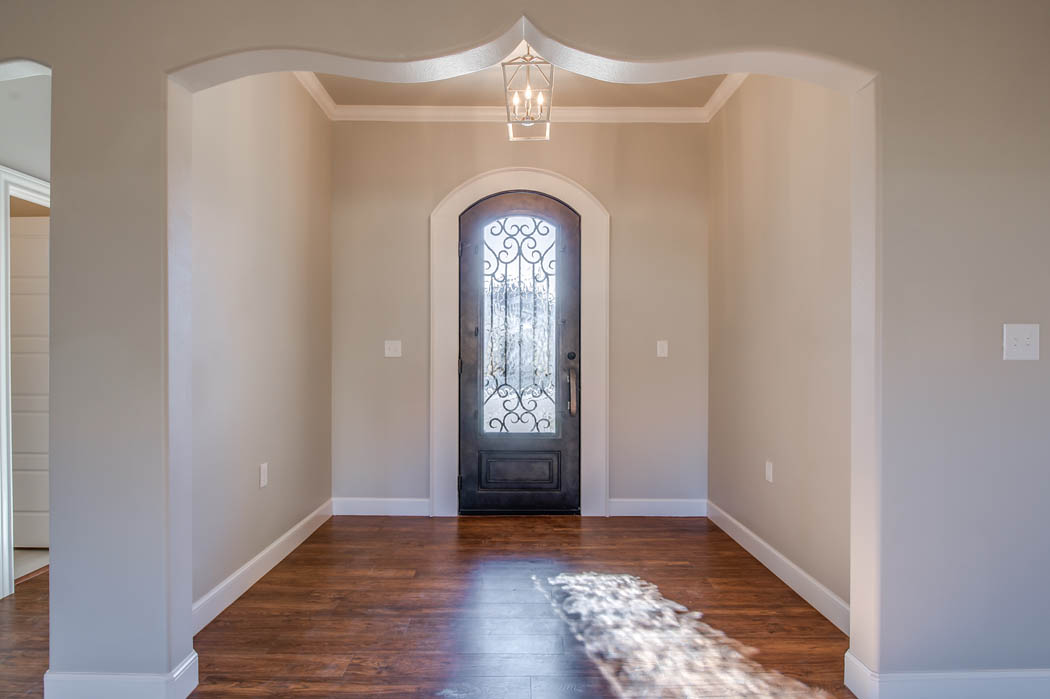 Beautiful entry with detailed doors in Lubbock, Texas home.