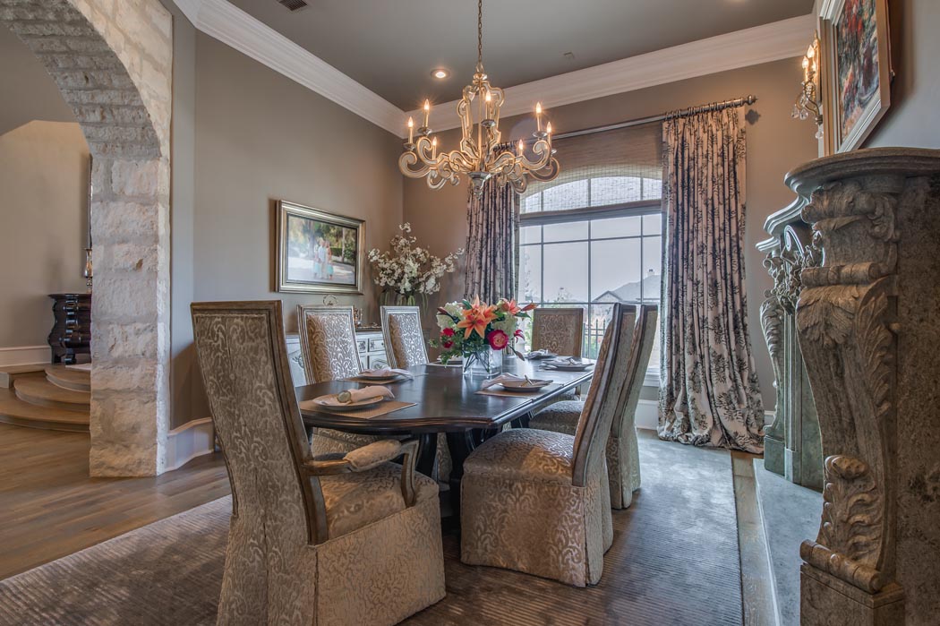 Spacious dining room with arched windows in custom home.