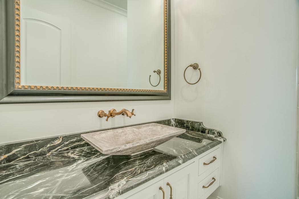 Vanity in guest bath of custom home, featuring bowl sink.
