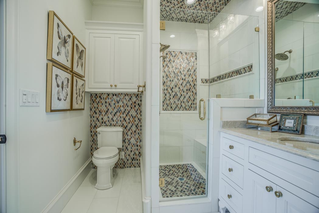 Bath in custom home with specialty vanity and sink features.