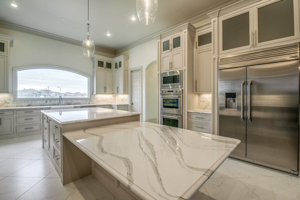 Kitchen with countertop bar in custom home by Sharkey Custom Homes in West Texas.