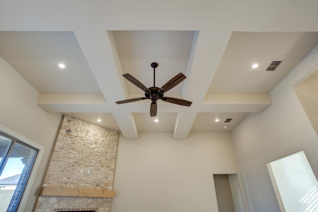 View of living area ceilling, with beam-like detail and ceiling fan, in new home for sale in Lubbock.