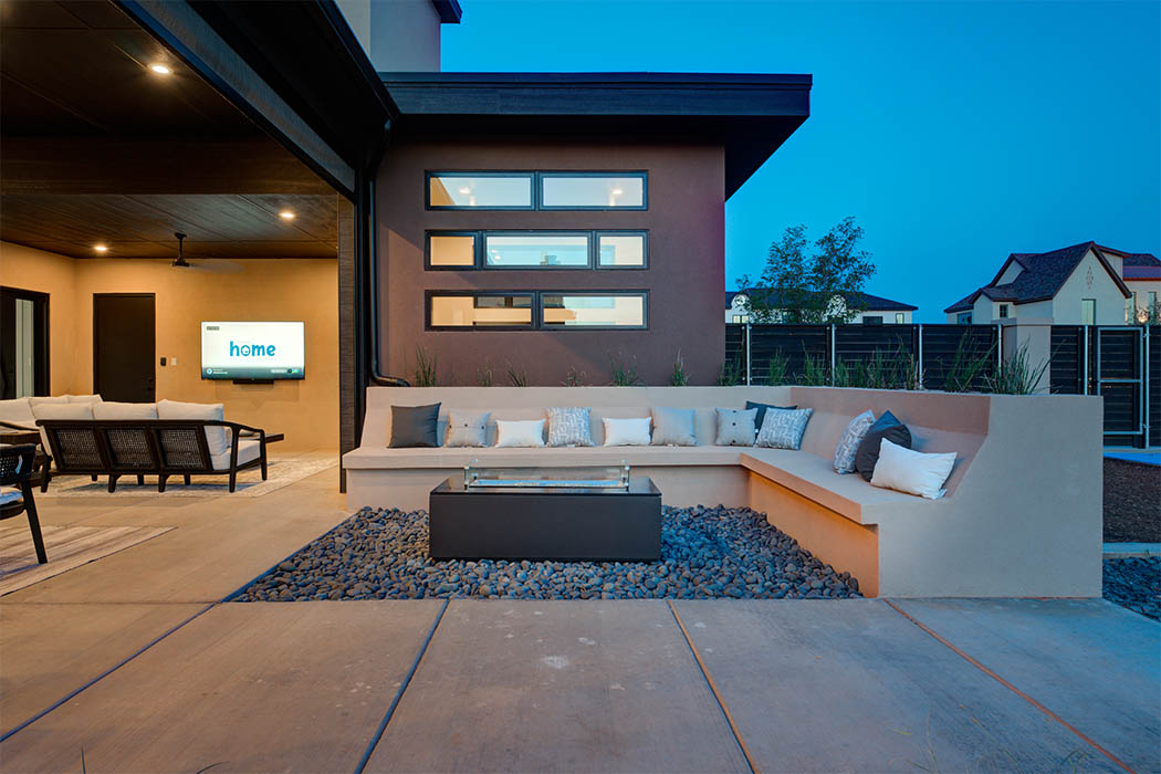 Beautiful seating area in covered patio, complete with television, in amazing custom home built in Lubbock.